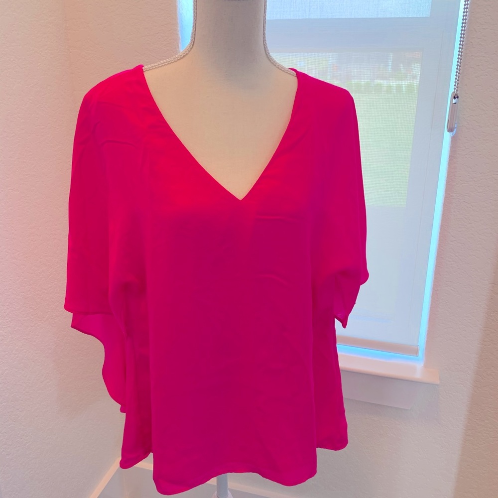 Woman’s bright pink blouse